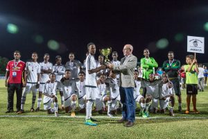 Fabian Whorms, CEO, Cayman Airways, presents the 2016 Cayman Airways Invitational Youth Cup to winners Cavalier FC.